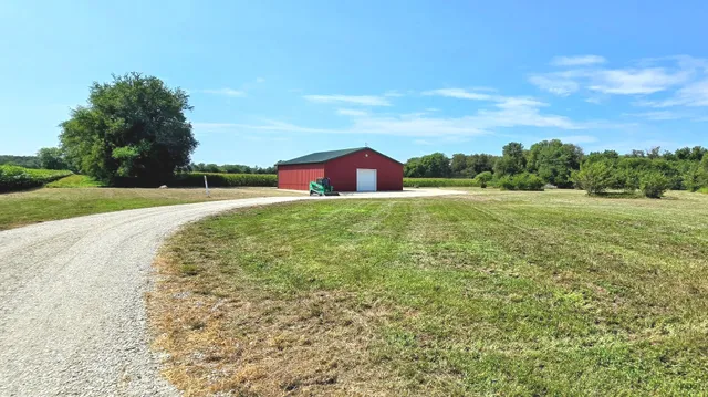 a view of a big yard with large trees