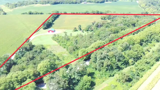 a close up of a white house with a yard and lake view