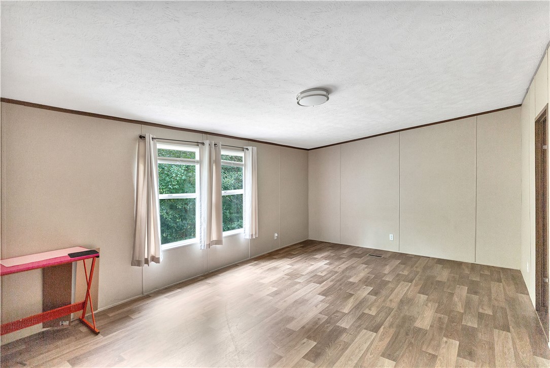 1309 Big Creek Road Belton, SC 29627 - Photo 10 of 21 Warm wood-look flooring and dual windows define this versatile living space.