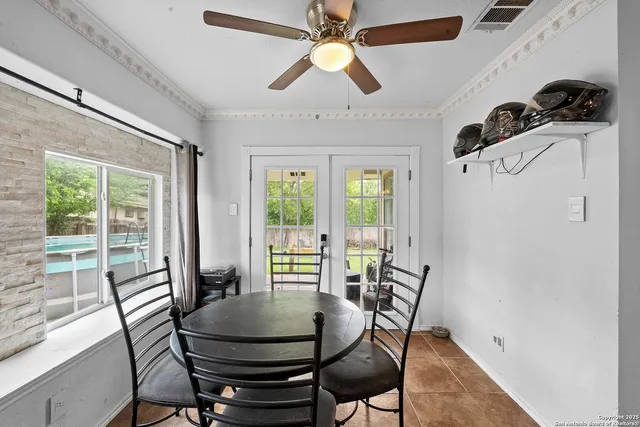 a dining room with furniture a chandelier and wooden floor