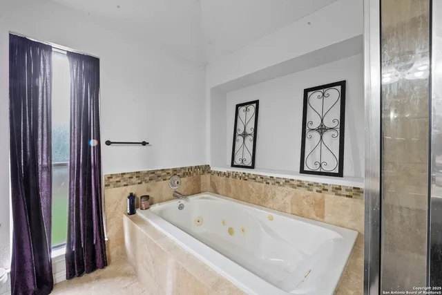 a bathroom with bathtub and window