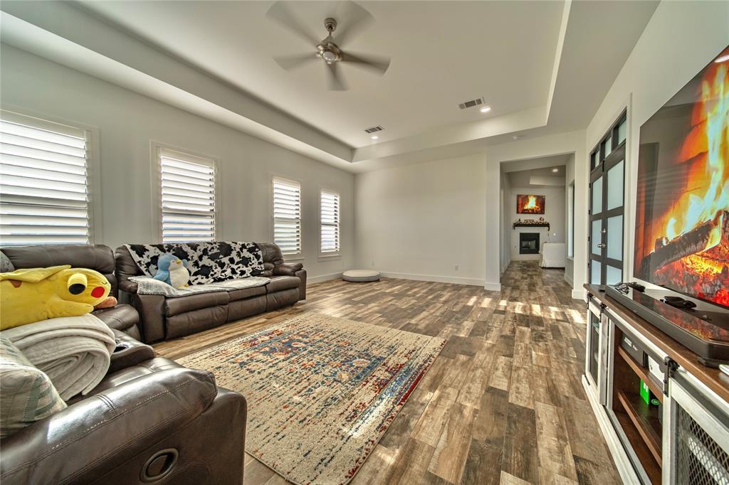 165 Ranch House Road Rockwall, TX 75032 - Photo 18 of 40 a bedroom with furniture and a flat screen tv