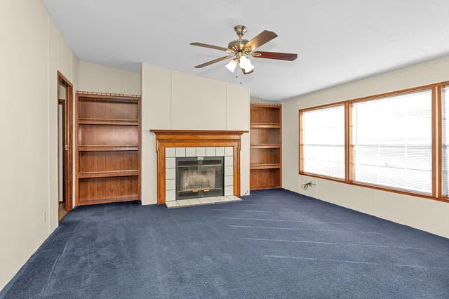 a view of kitchen with furniture stainless steel appliances and window