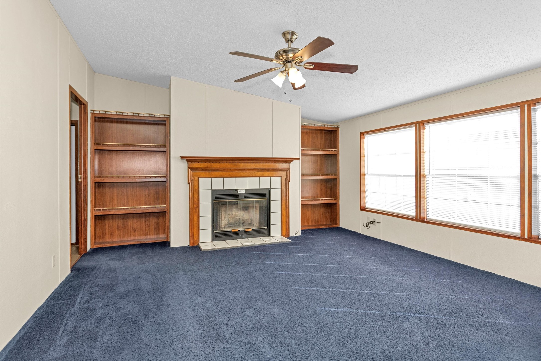 11261 Rose Road Conroe, TX 77303 - Photo 13 of 30 a view of an empty room with a fireplace and a window