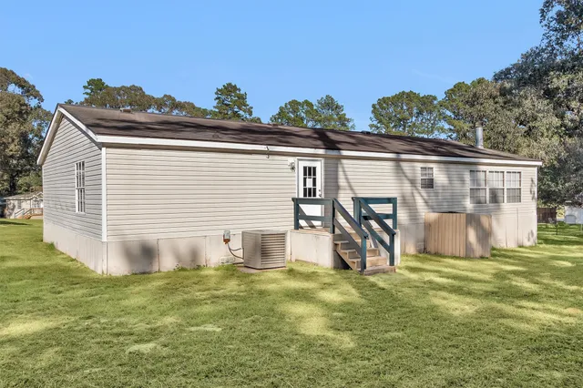 a view of a backyard with a garden and entertaining space