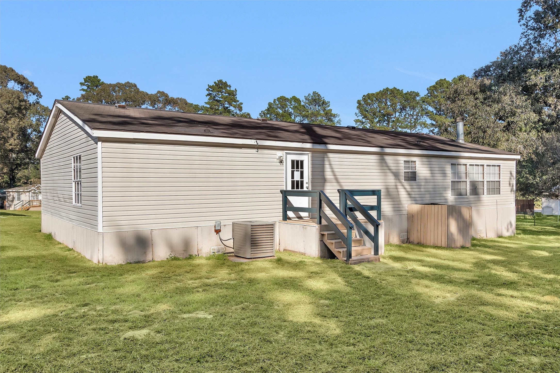 11261 Rose Road Conroe, TX 77303 - Photo 29 of 30 a view of a house with backyard and a tree