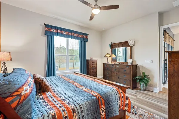 a bedroom with a large bed and a large window