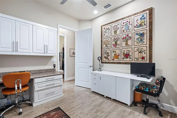 a view of workspace with wooden floor windows cabinet