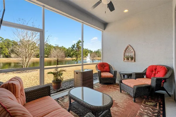 a living room with furniture and a floor to ceiling window