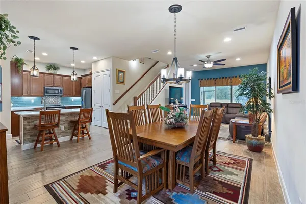 a dining room with furniture and wooden floor