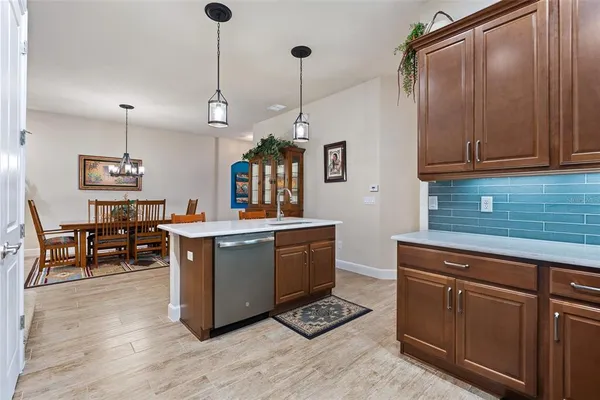 a kitchen with sink cabinets and wooden floor