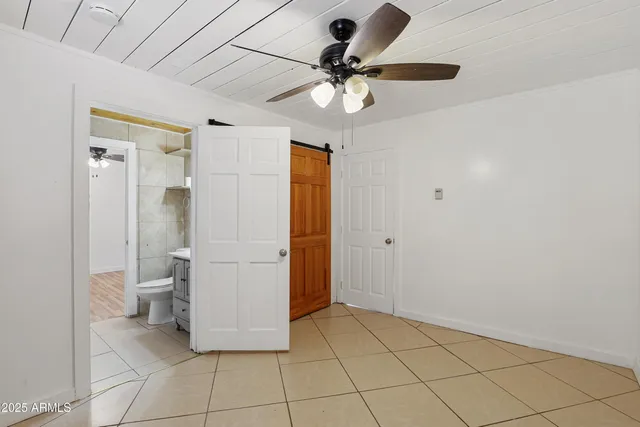 a bathroom with a glass door shower a toilet and a sink
