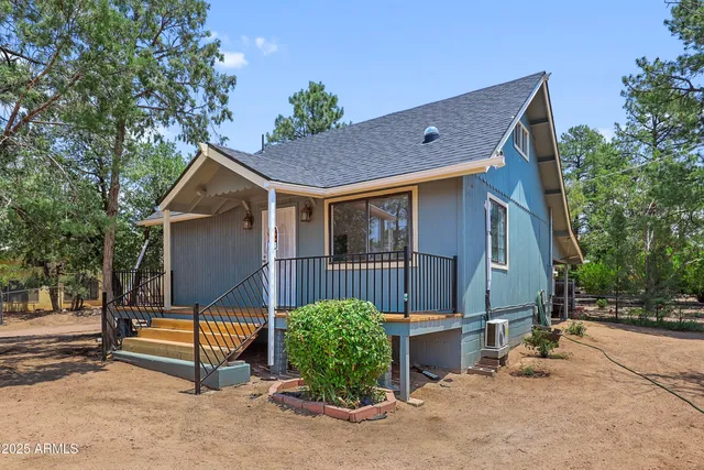 a view of a house with wooden fence next to a road