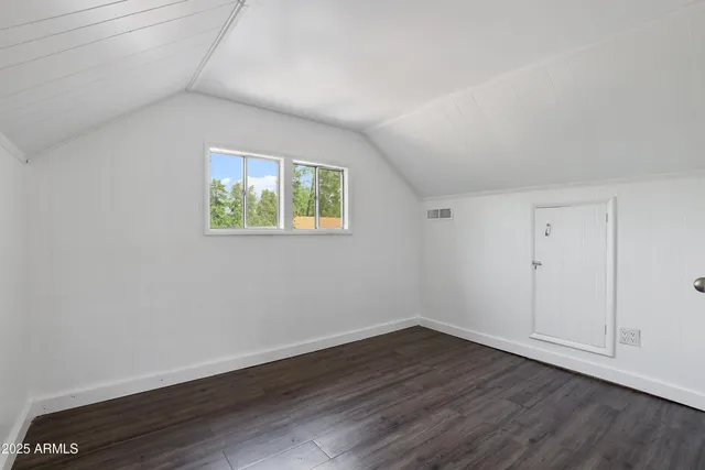 a view of room with hardwood floor and window