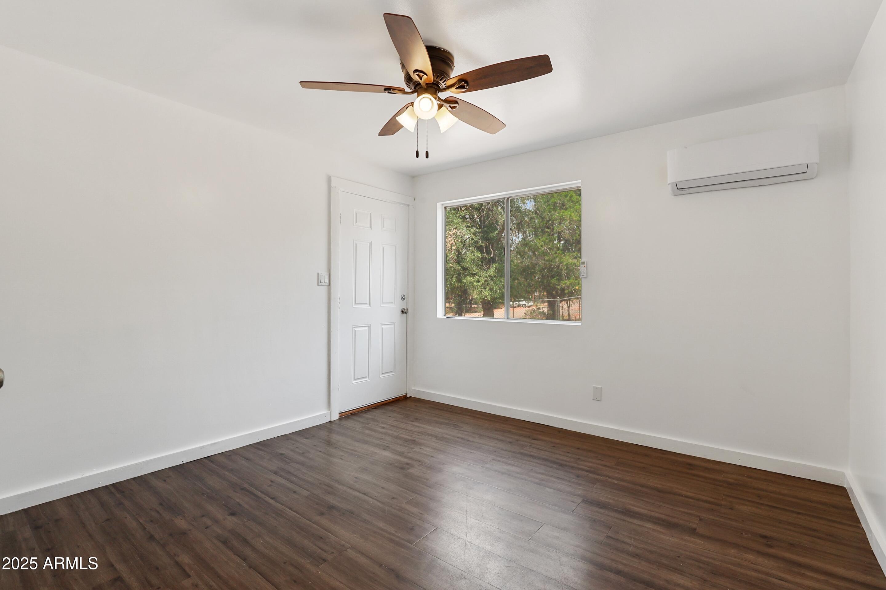809 North Colcord Road Payson, AZ 85541 - Photo 27 of 34 an empty room with wooden floor and ceiling fan