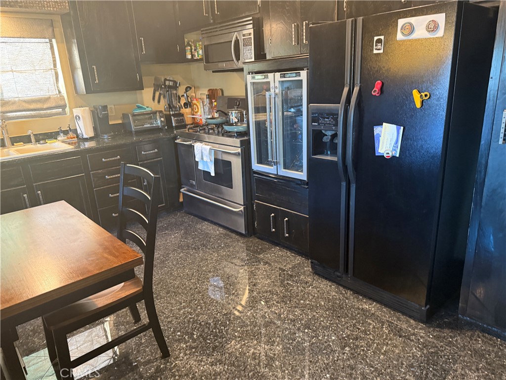 728 West 11th Street San Pedro, CA 90731 - Photo 3 of 13 a kitchen with stainless steel appliances granite countertop a refrigerator and stove