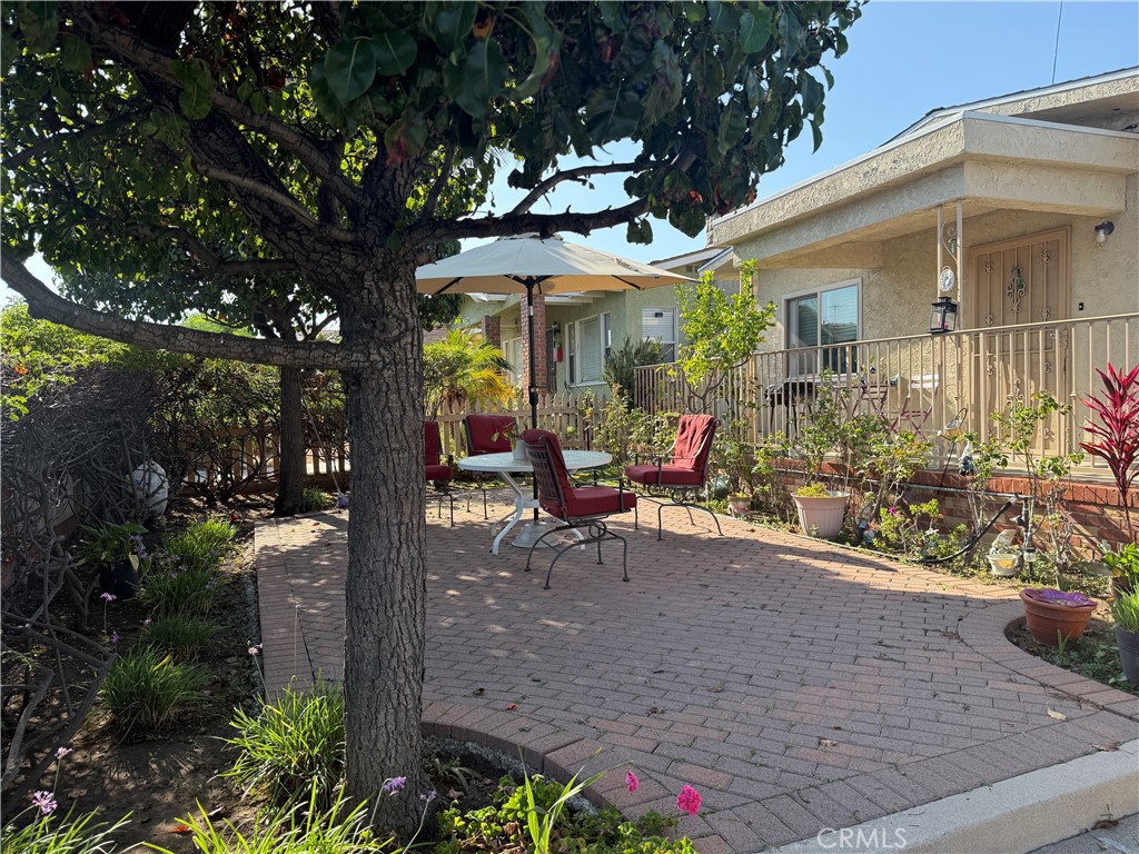 728 West 11th Street San Pedro, CA 90731 - Photo 6 of 13 a view of a patio with table and chairs potted plants and large tree