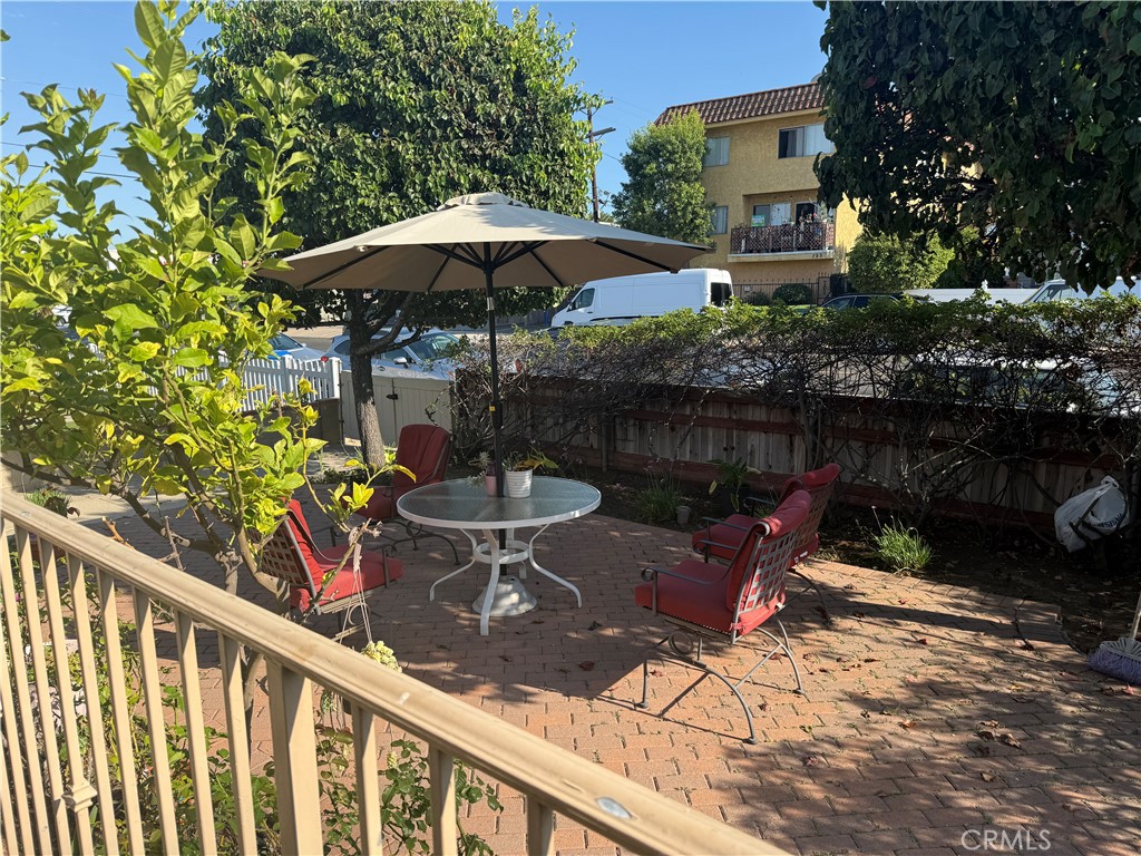 728 West 11th Street San Pedro, CA 90731 - Photo 8 of 13 a view of a table and chairs under an umbrella in backyard