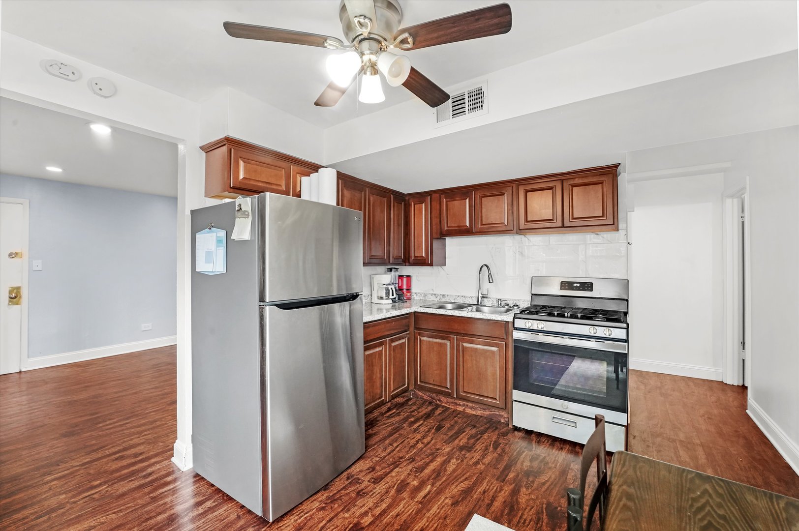 8119 South Paulina Street Chicago, IL 60620 - Photo 12 of 19 a kitchen with stainless steel appliances a stove a refrigerator and a sink