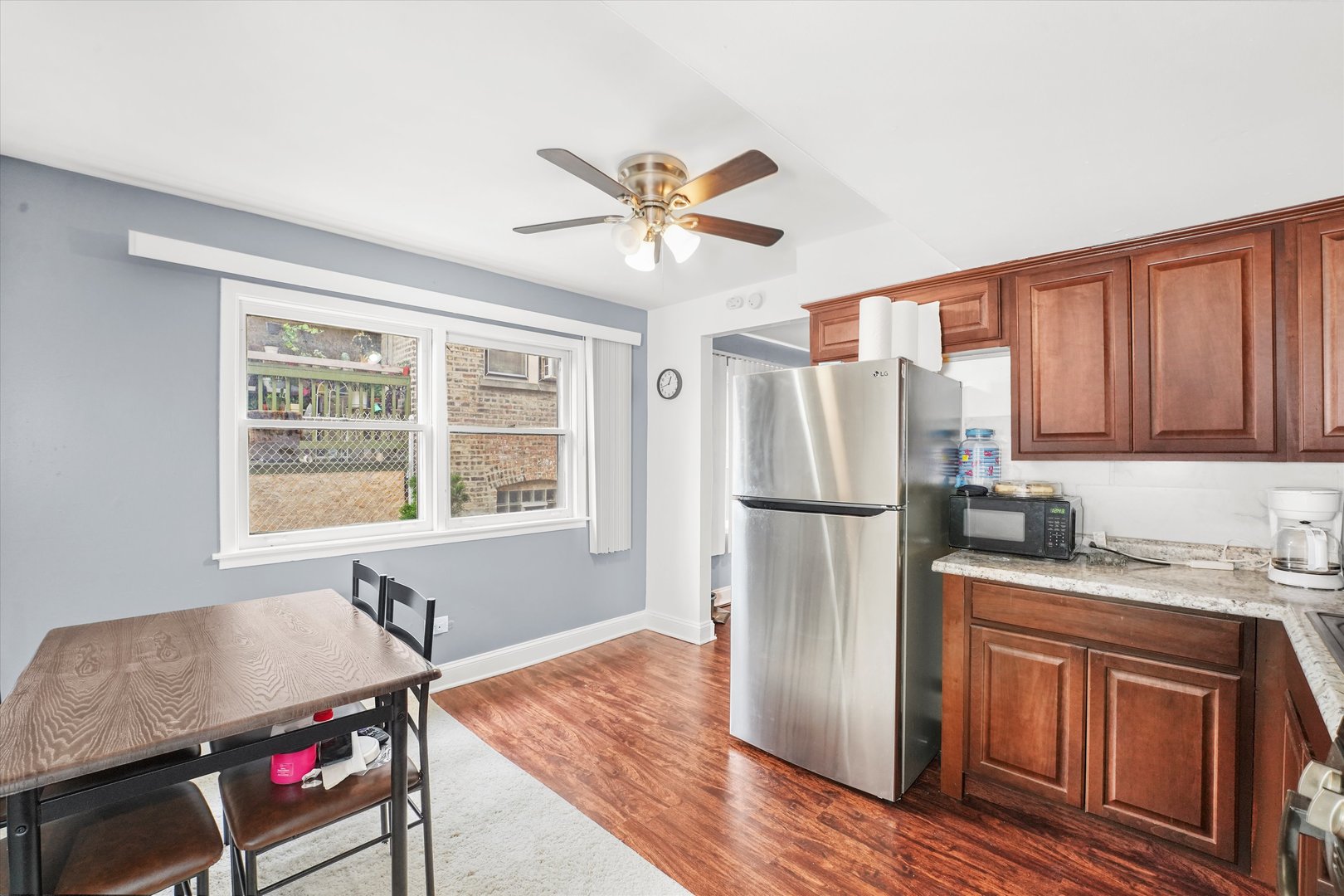 8119 South Paulina Street Chicago, IL 60620 - Photo 13 of 19 a kitchen with stainless steel appliances granite countertop a refrigerator a stove a sink and dishwasher with wooden floors