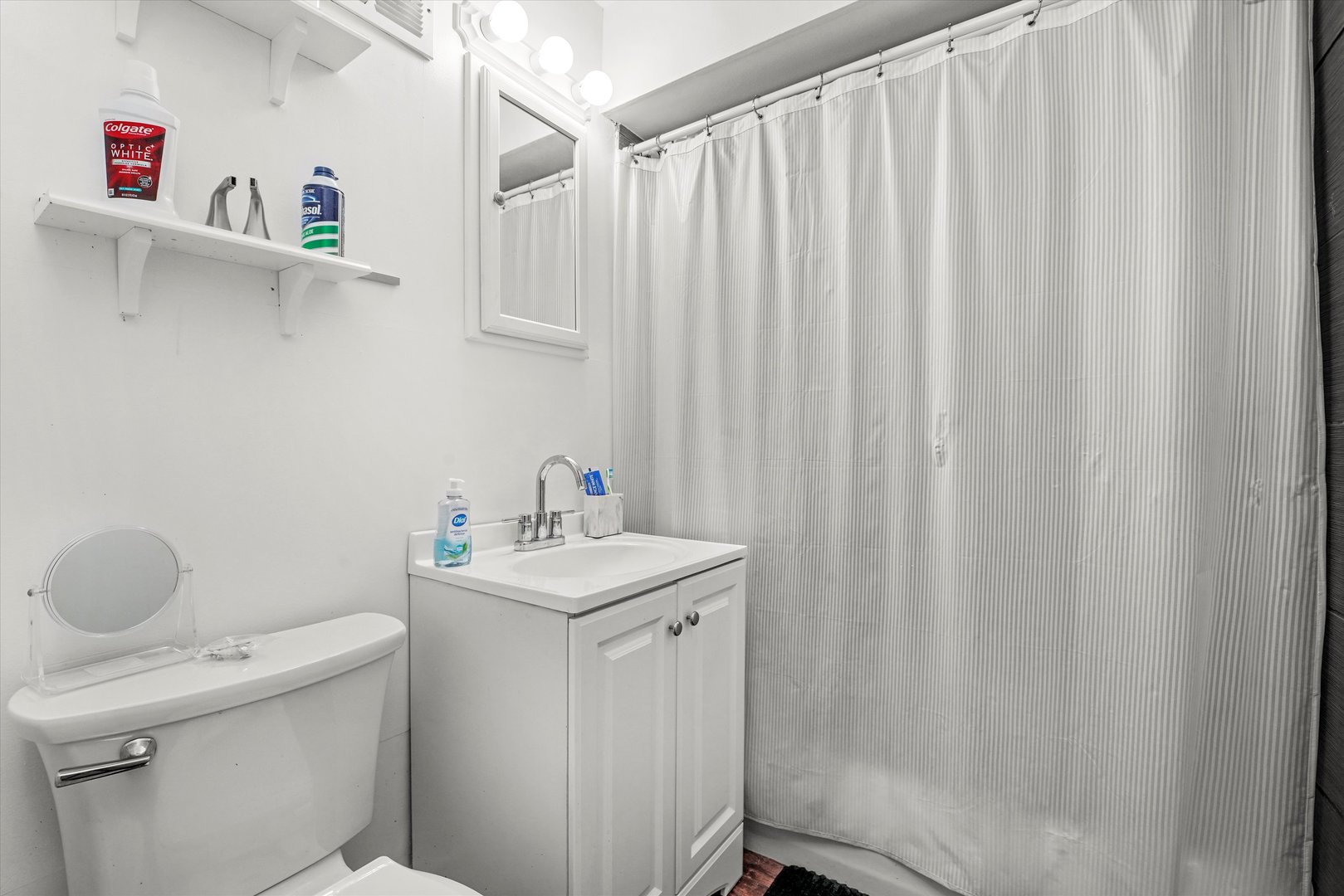 8119 South Paulina Street Chicago, IL 60620 - Photo 15 of 19 a bathroom with a sink a toilet and a mirror