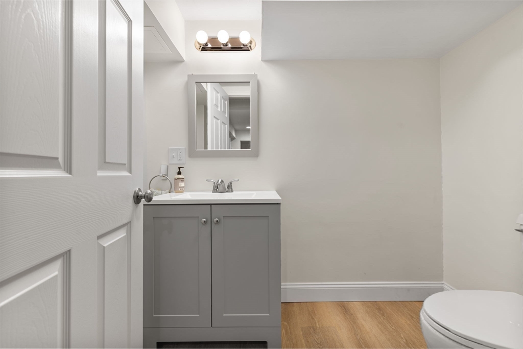 424 Brook Road Milton, MA 02186 - Photo 30 of 41 a bathroom with a sink vanity and toilet