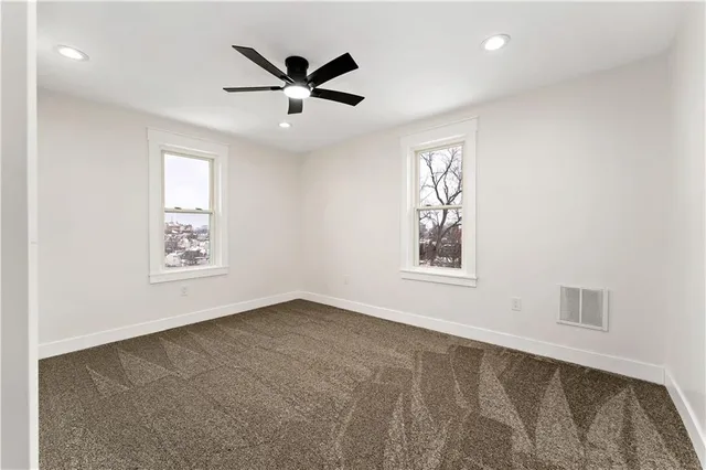 a view of an empty room with windows