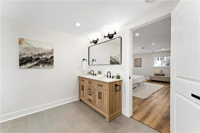 a bathroom with a tub a mirror and a shower