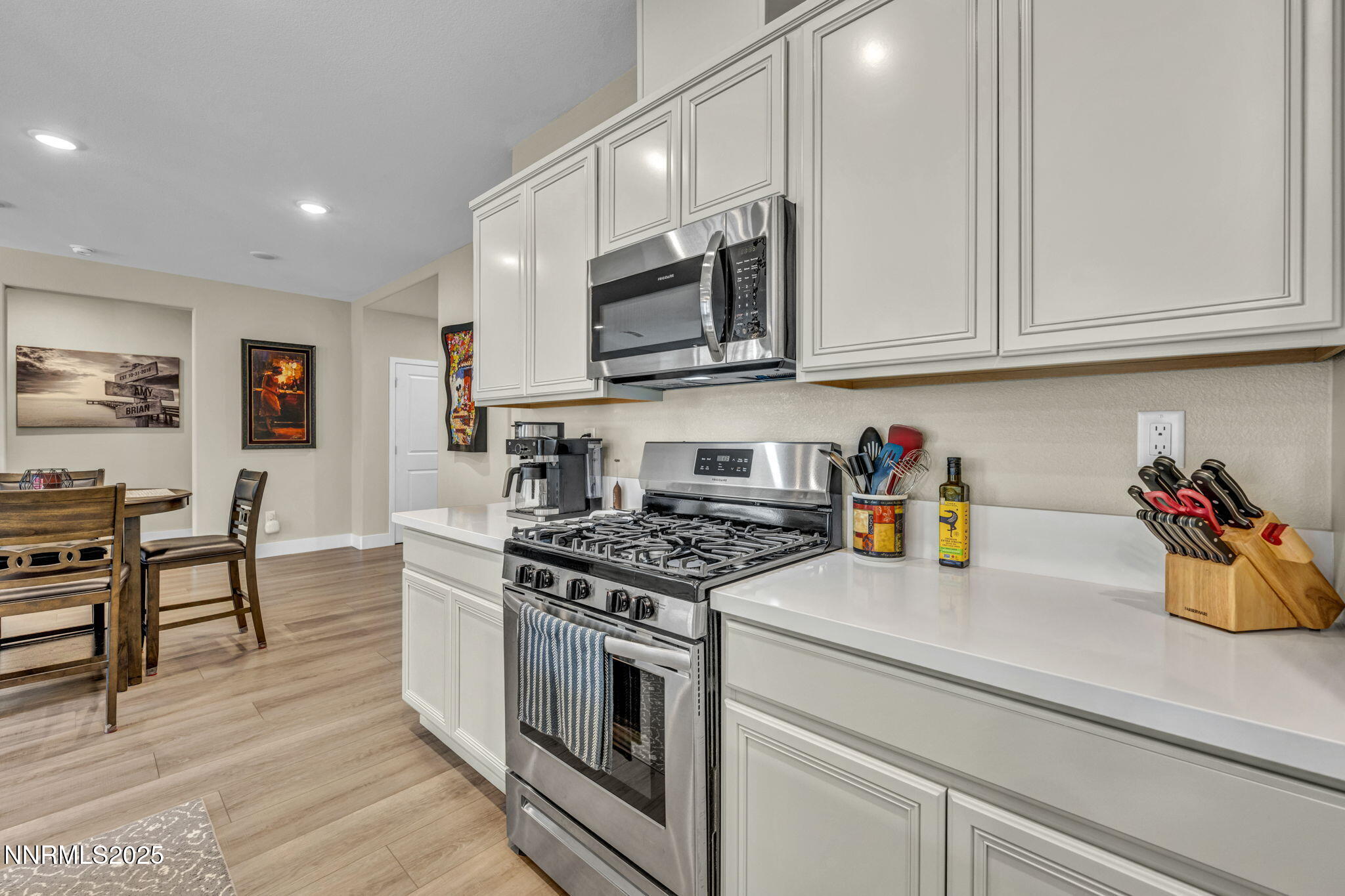 32 Stellar Court Carson City, NV 89705 - Photo 11 of 49 a kitchen with stainless steel appliances granite countertop a stove a sink and a microwave