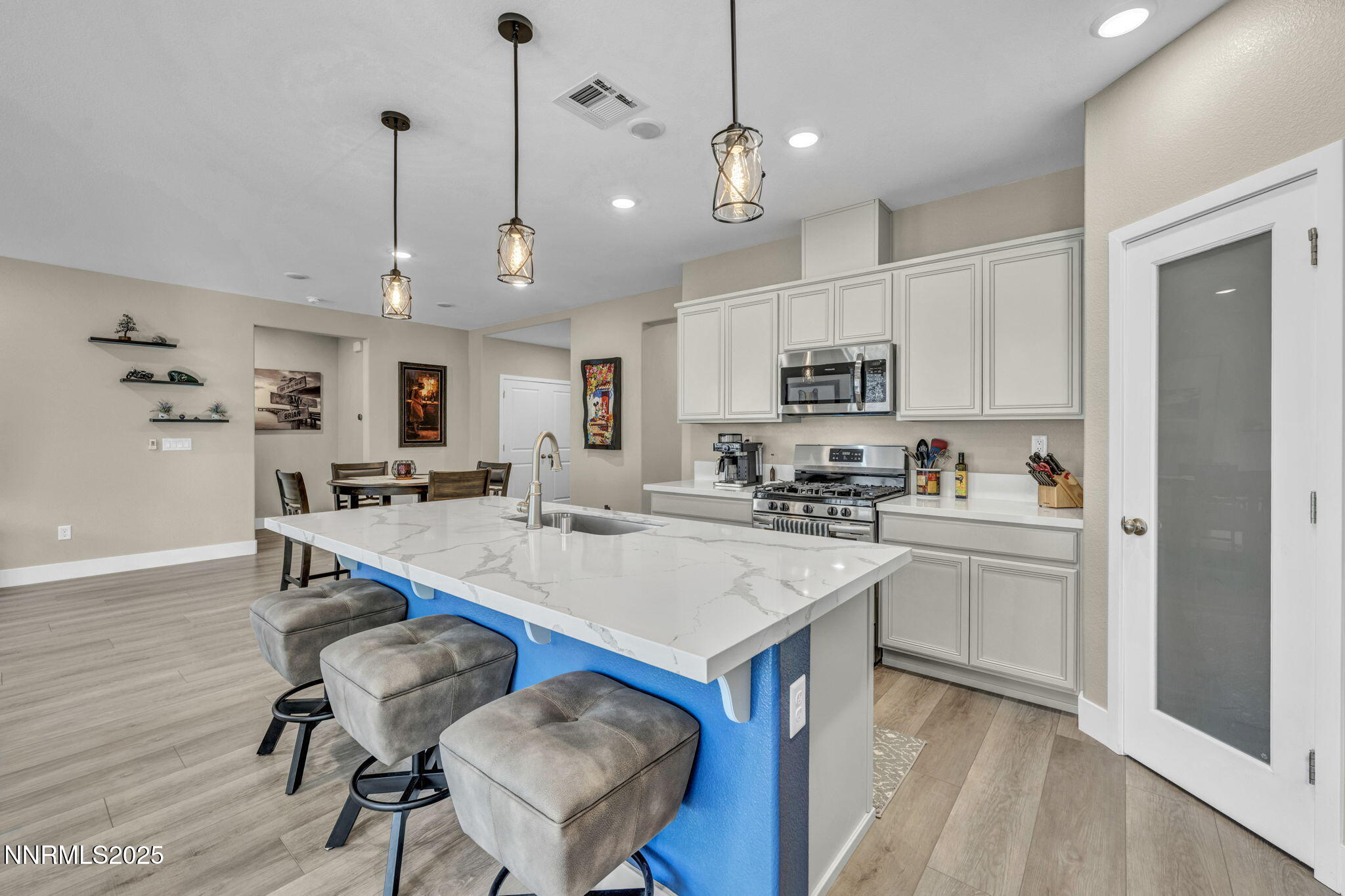 32 Stellar Court Carson City, NV 89705 - Photo 14 of 49 a kitchen with a dining table chairs stainless steel appliances and cabinets