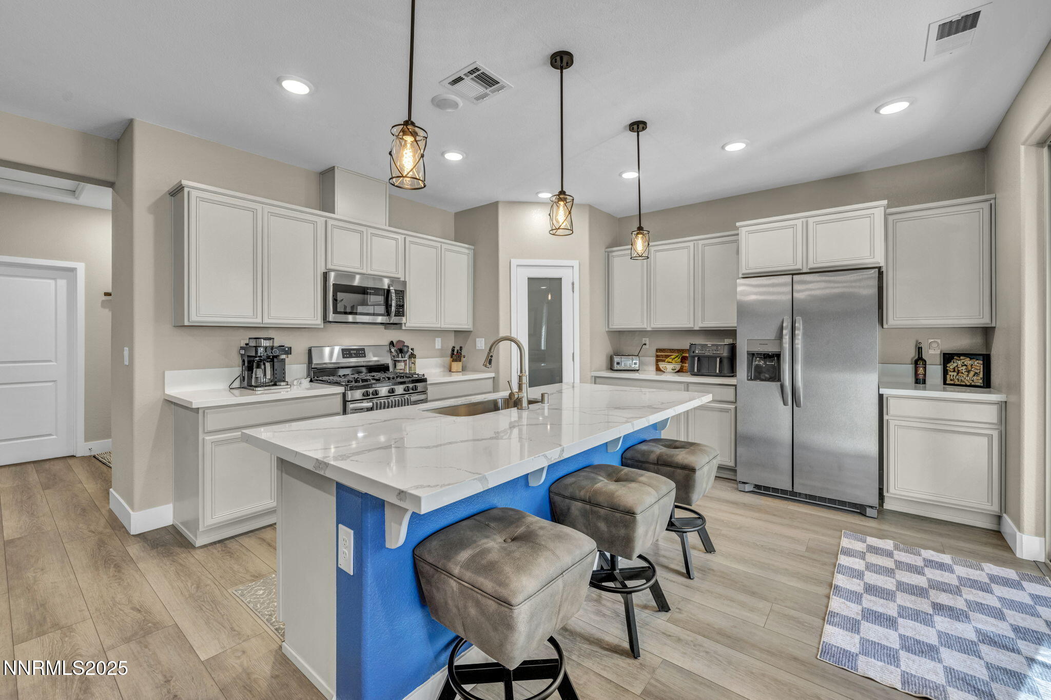 32 Stellar Court Carson City, NV 89705 - Photo 15 of 49 a kitchen with kitchen island white cabinets and stainless steel appliances