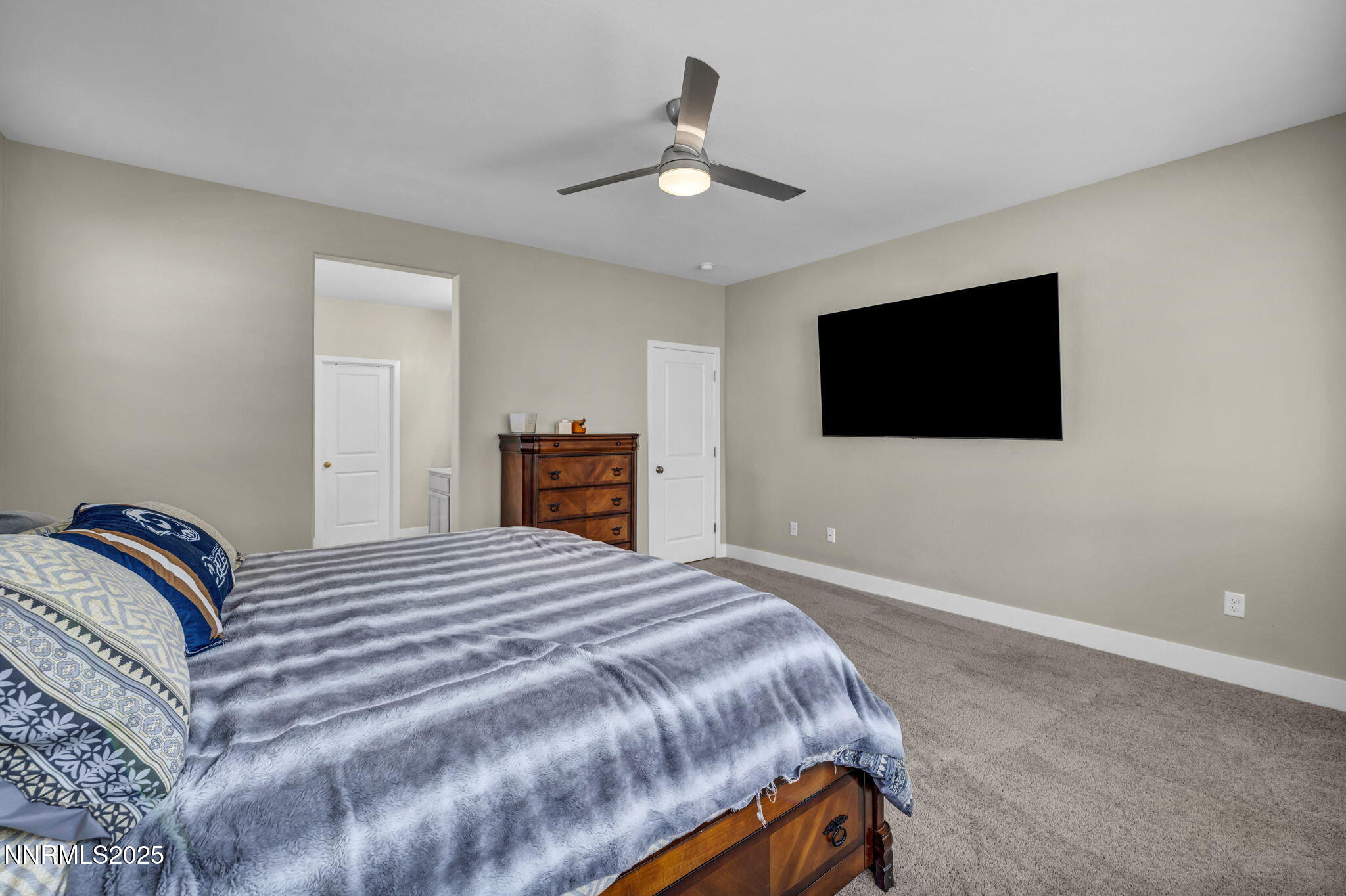 32 Stellar Court Carson City, NV 89705 - Photo 17 of 49 a bedroom with a bed and a flat screen tv