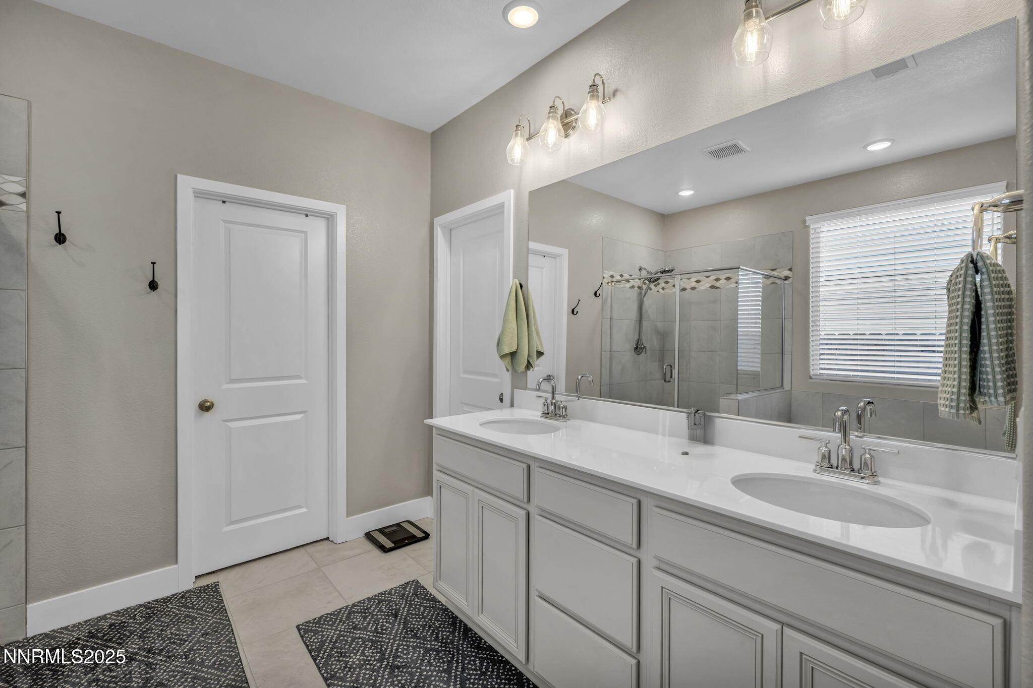 32 Stellar Court Carson City, NV 89705 - Photo 20 of 49 a bathroom with a double vanity sink and mirror