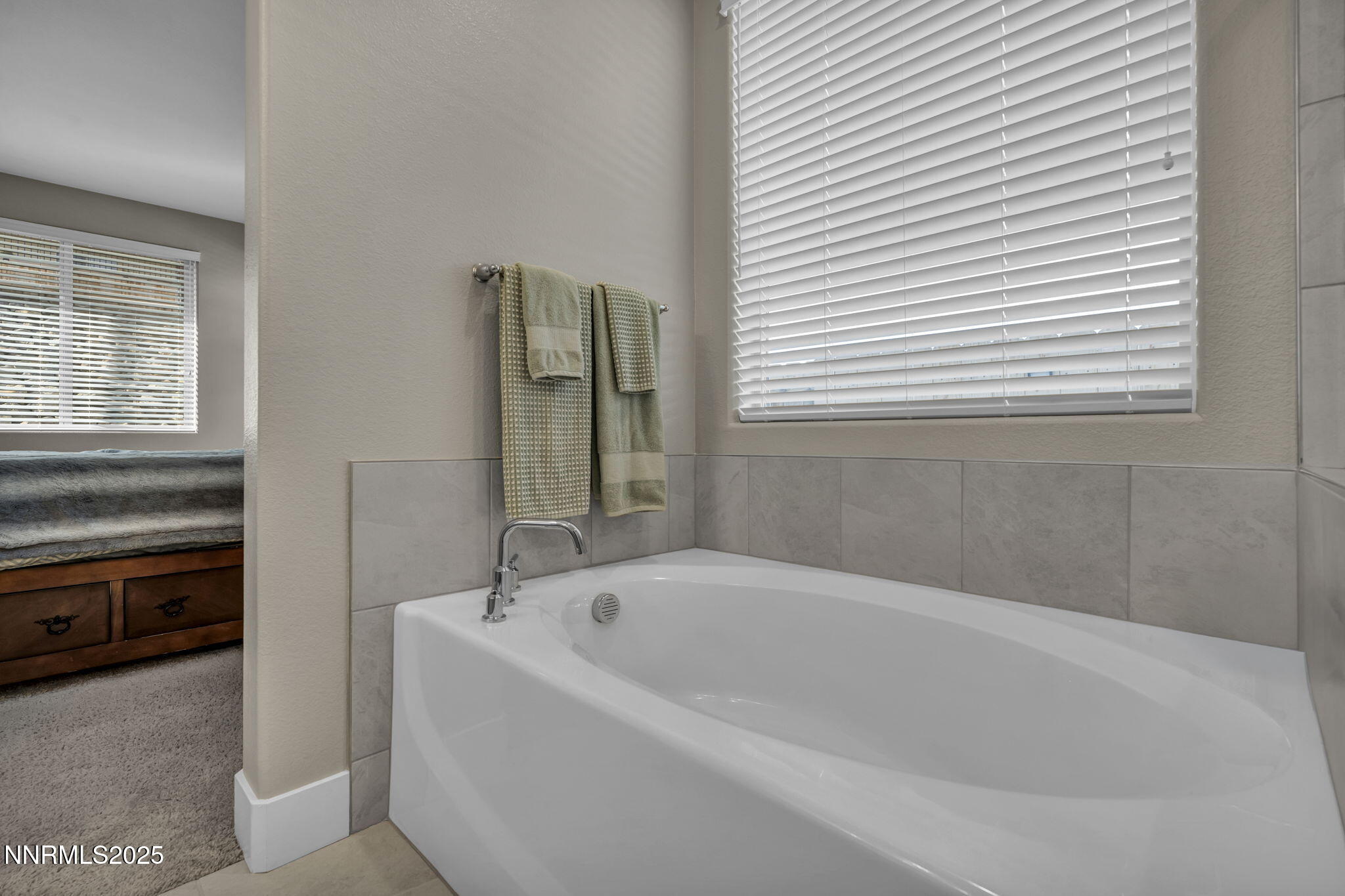 32 Stellar Court Carson City, NV 89705 - Photo 21 of 49 a white bath tub sitting in a bathroom next to a window