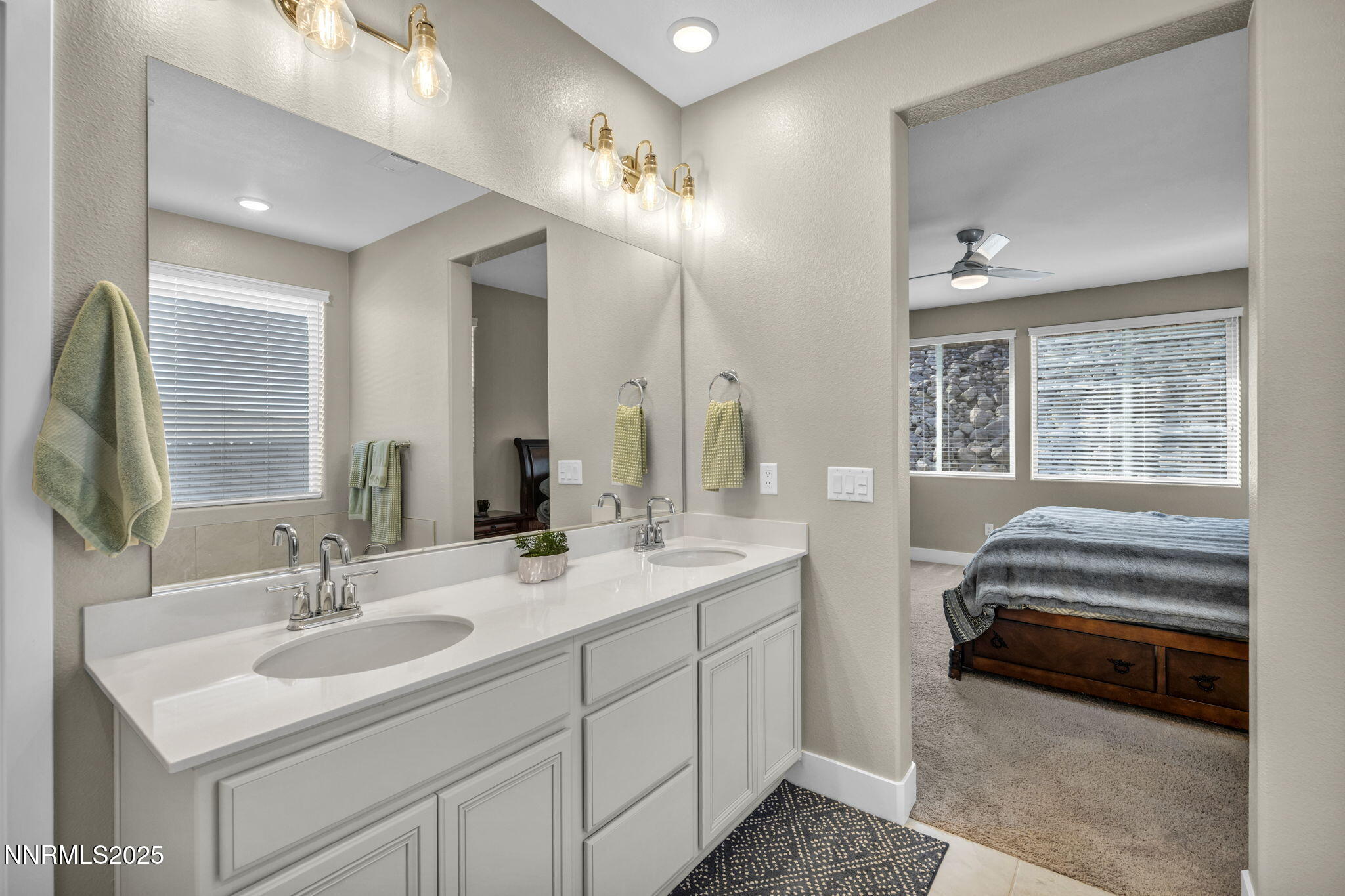 32 Stellar Court Carson City, NV 89705 - Photo 23 of 49 a en suite bathroom with double vanity a mirror and a sink