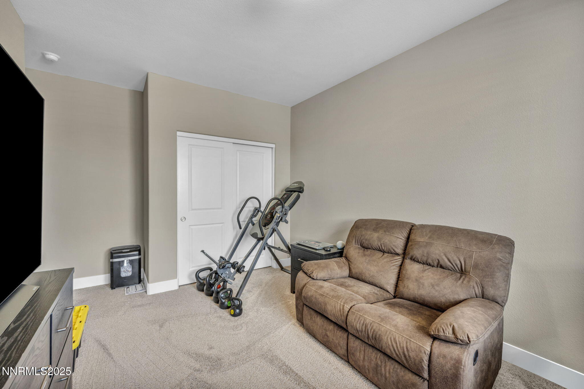 32 Stellar Court Carson City, NV 89705 - Photo 25 of 49 a living room with furniture and a gym machine