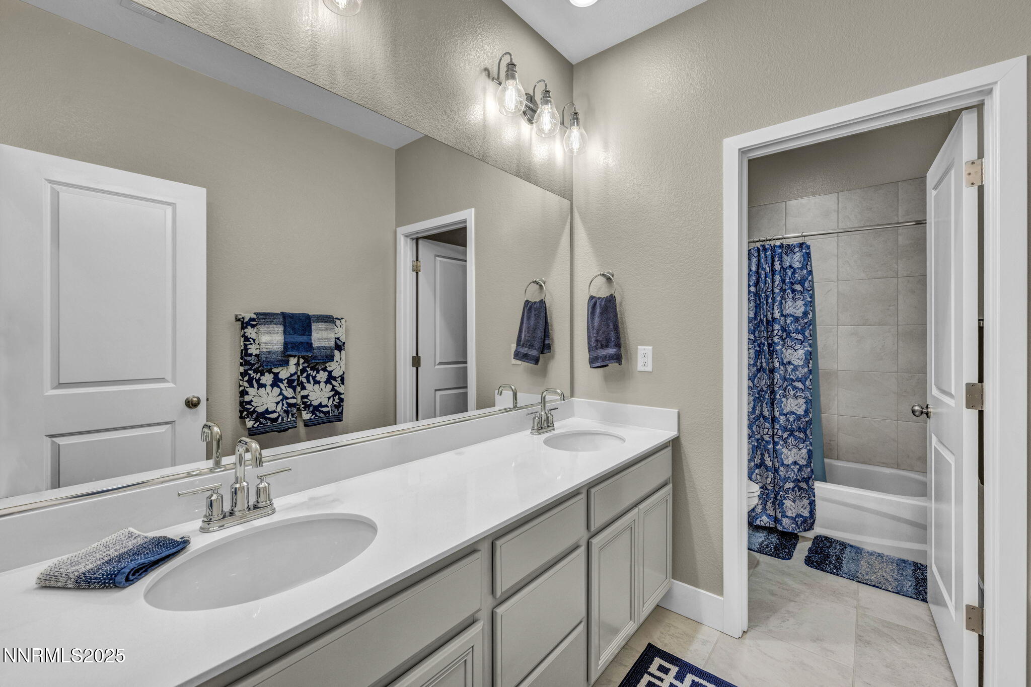 32 Stellar Court Carson City, NV 89705 - Photo 30 of 49 a bathroom with a sink double vanity and a mirror