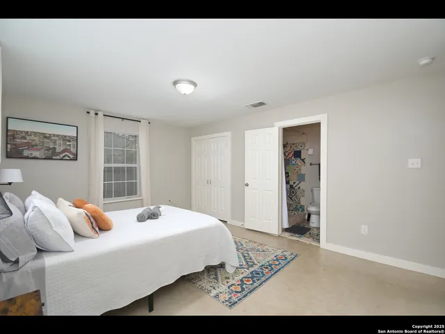 a bedroom with a bed and a view of bathroom