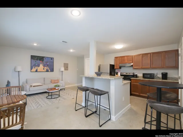 a kitchen with stainless steel appliances kitchen island granite countertop a sink and cabinets