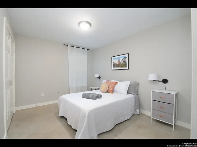 a bedroom with a bed and a lamp