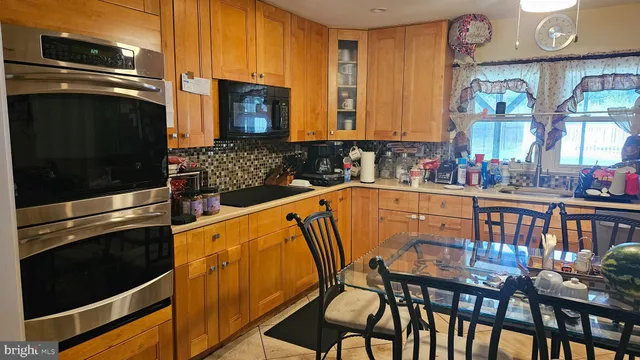 a kitchen view with table and chairs