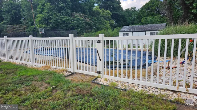 a view of a fence with a small yard