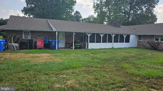 a view of a house with a yard and sitting area