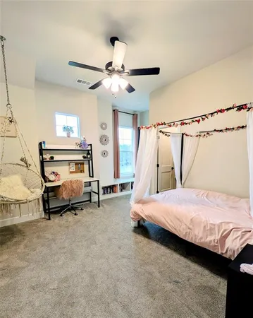 a bedroom with a bed and a ceiling fan