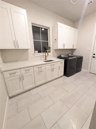 a kitchen with a sink and cabinets