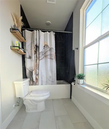 a bathroom with a toilet a sink and a bathtub