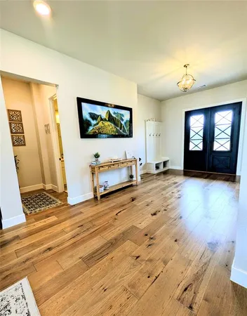 a view of a livingroom with furniture and a flat screen tv