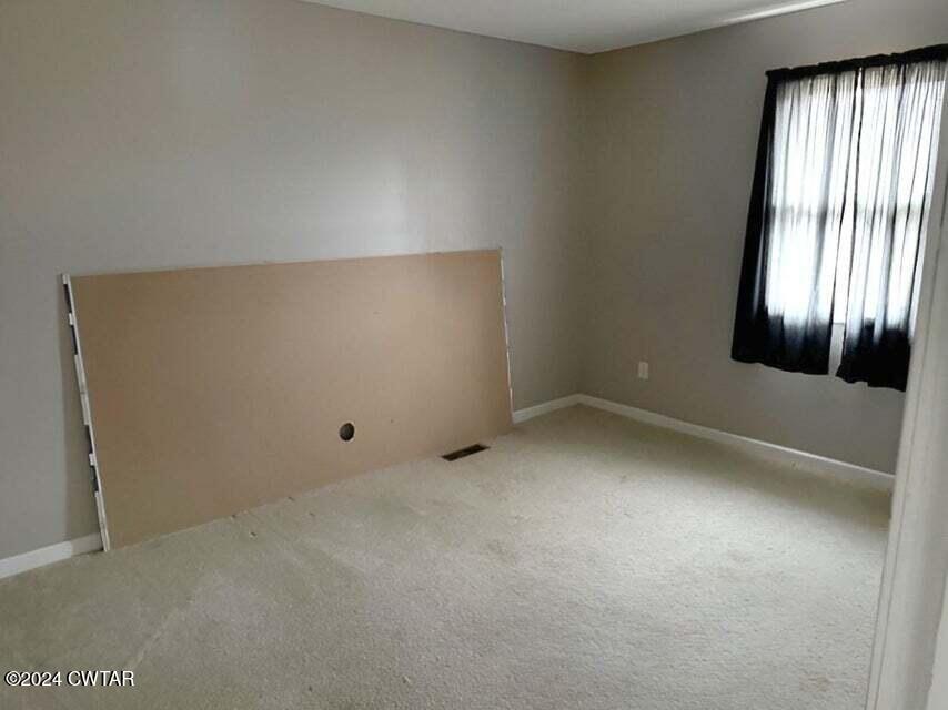 1759 Janes Mill Road Gleason, TN 38229 - Photo 17 of 18 an empty room with windows