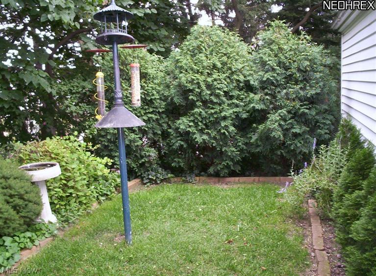 11712 Granger Road Cleveland, OH 44125 - Photo 3 of 13 The backyard has lush landscaping that gives you privacy.