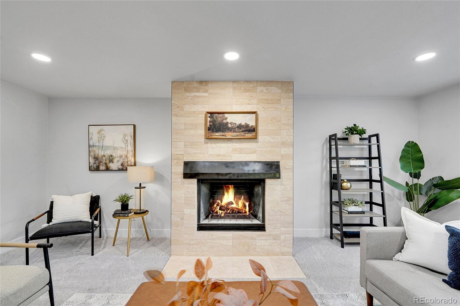 3261 South Oneida Way Denver, CO 80224 - Photo 17 of 43 a living room with furniture and a fireplace